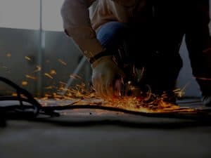 Man welding in backyard