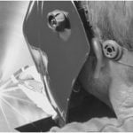 Welding being done with Welder with mask.
