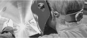 Welding being done with Welder with mask.