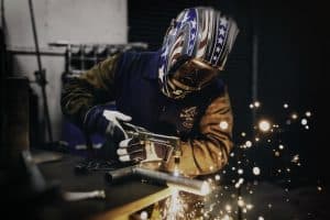 Man using Welding Supplies and safety equipment