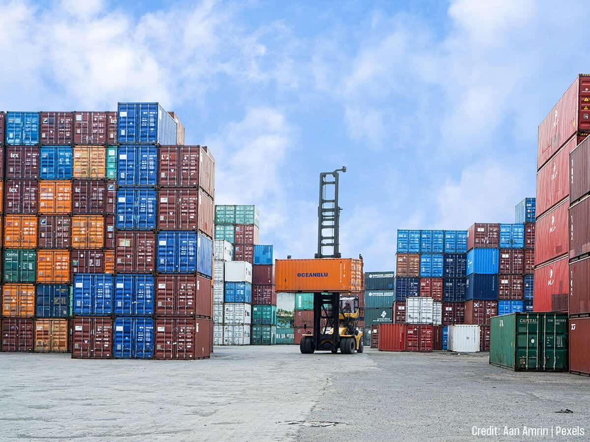 Man sculpting metal with tools in a creative workshop space.